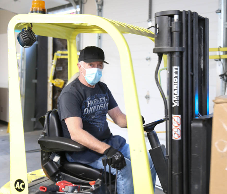 Man driving forklift.