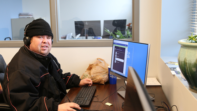 Man with head phones, working on computer.