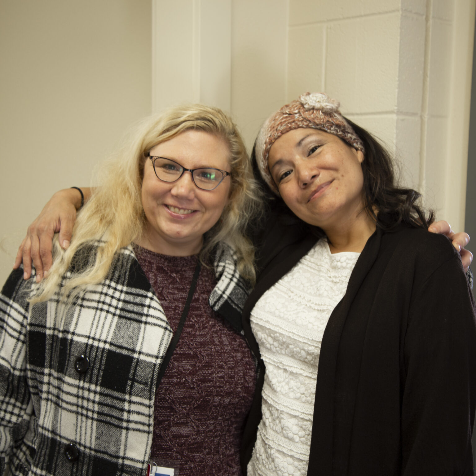 A HEN staff member and client pose for a photo.