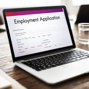 A laptop with an employment application on the screen.
