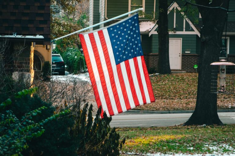 An American flag posted to a home in a neighborhood.