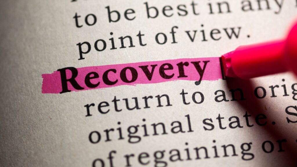 A page with text, the word "recovery" is being highlighted by a pink highlighter.