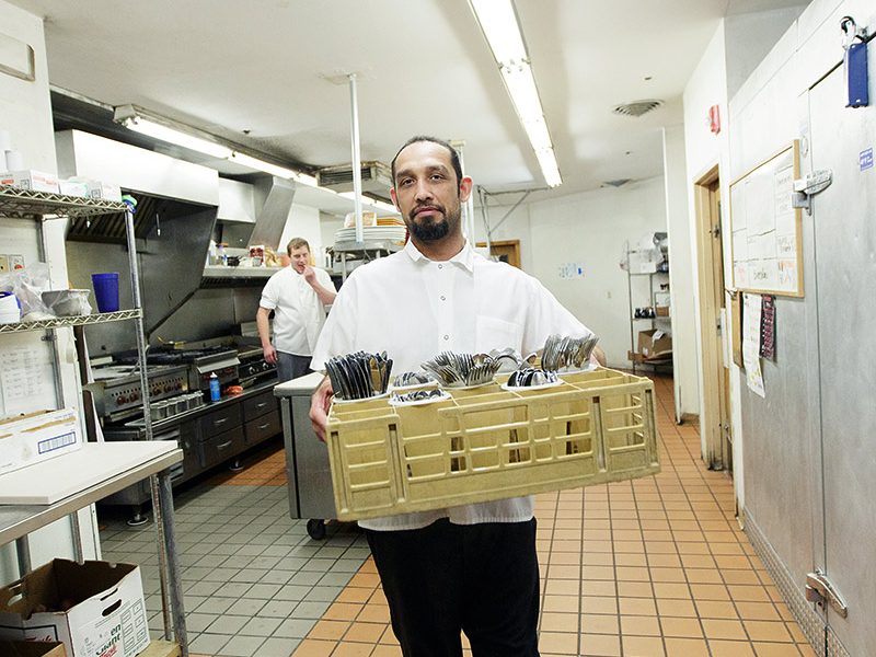 man with restaurant dish tray.