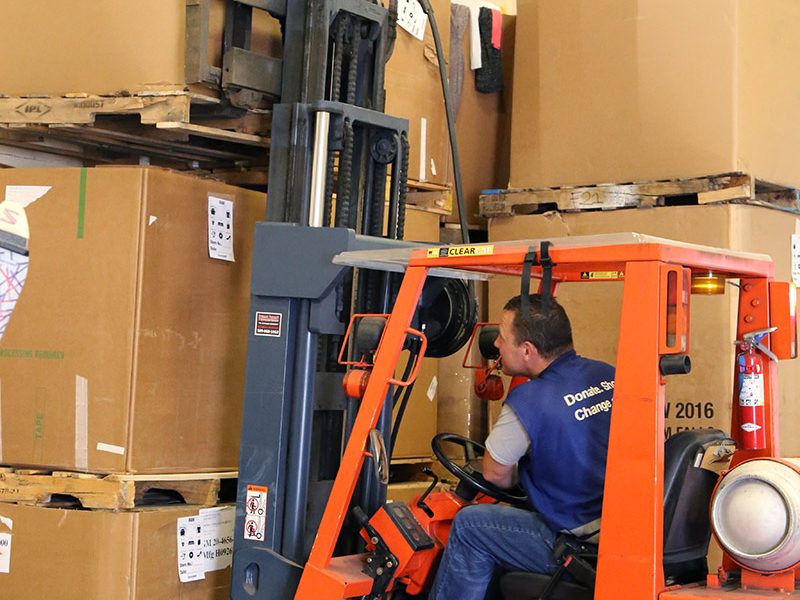 Goodwill employee operating forklift.